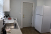 Small kitchen with white refrigerator