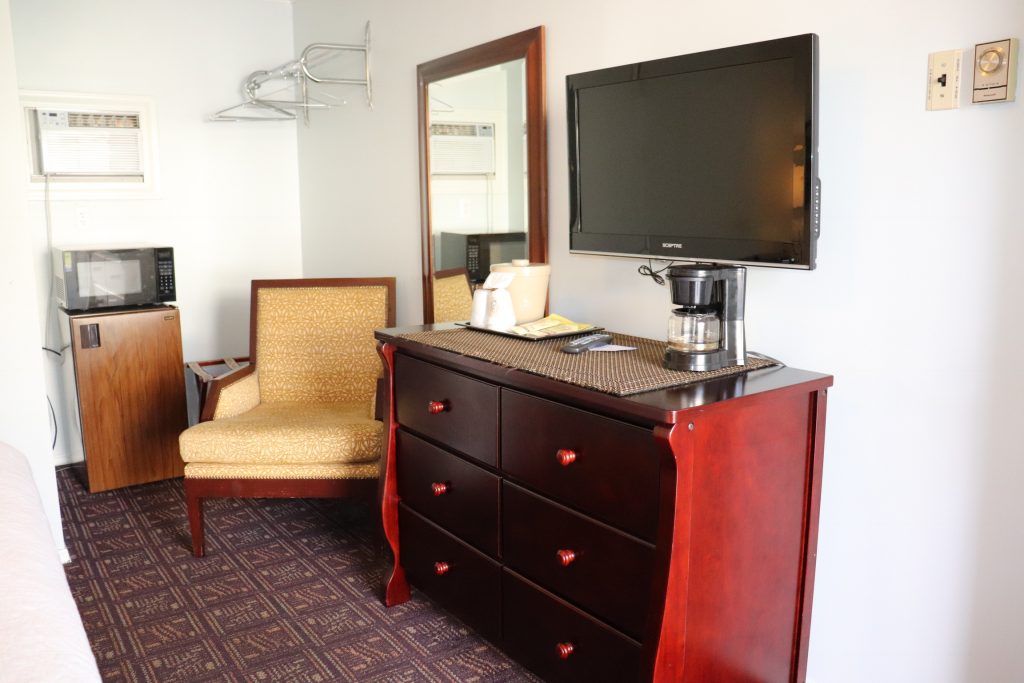 King room dresser with wall mounted TV and chair