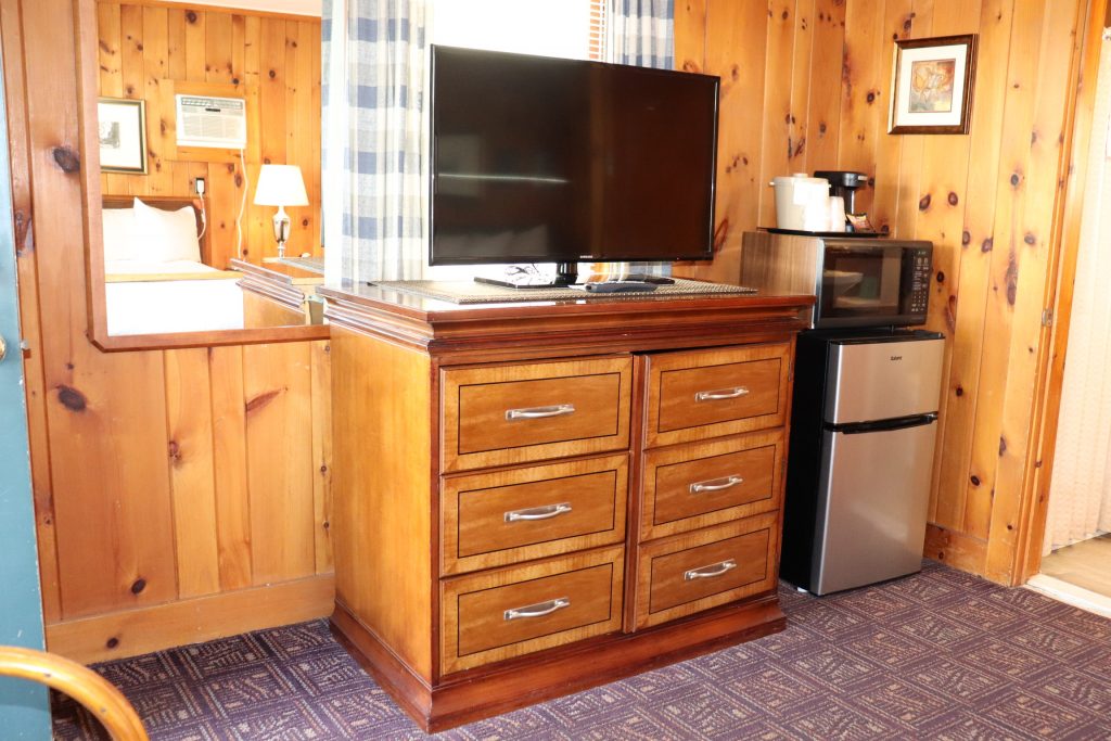 Cottage dresser with TV, mini-fridge, and microwave